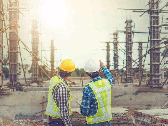 Two young man architect on a building construction site