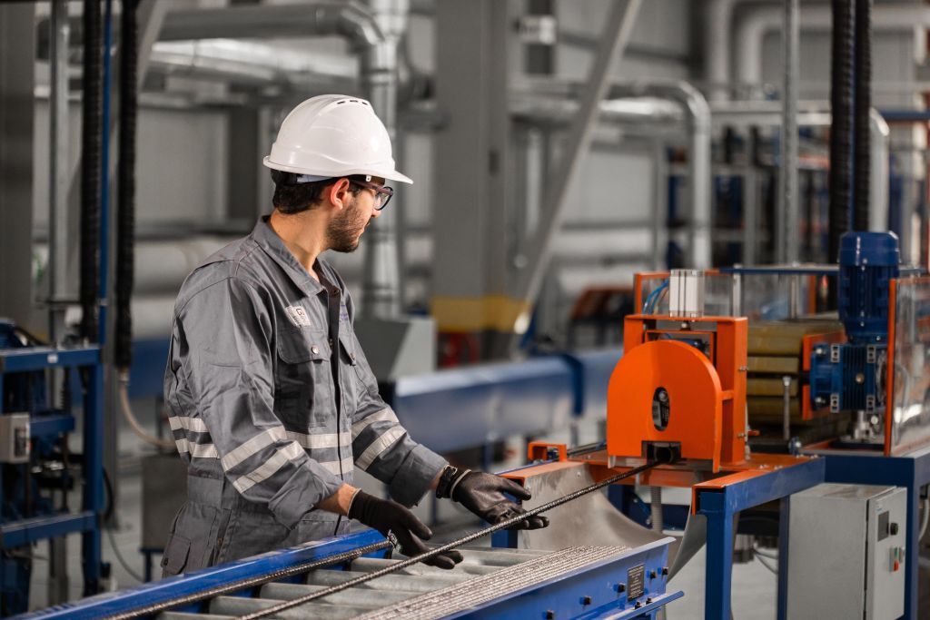 Arab Basalt Fiber Company worker in protective gear supervising machine operations