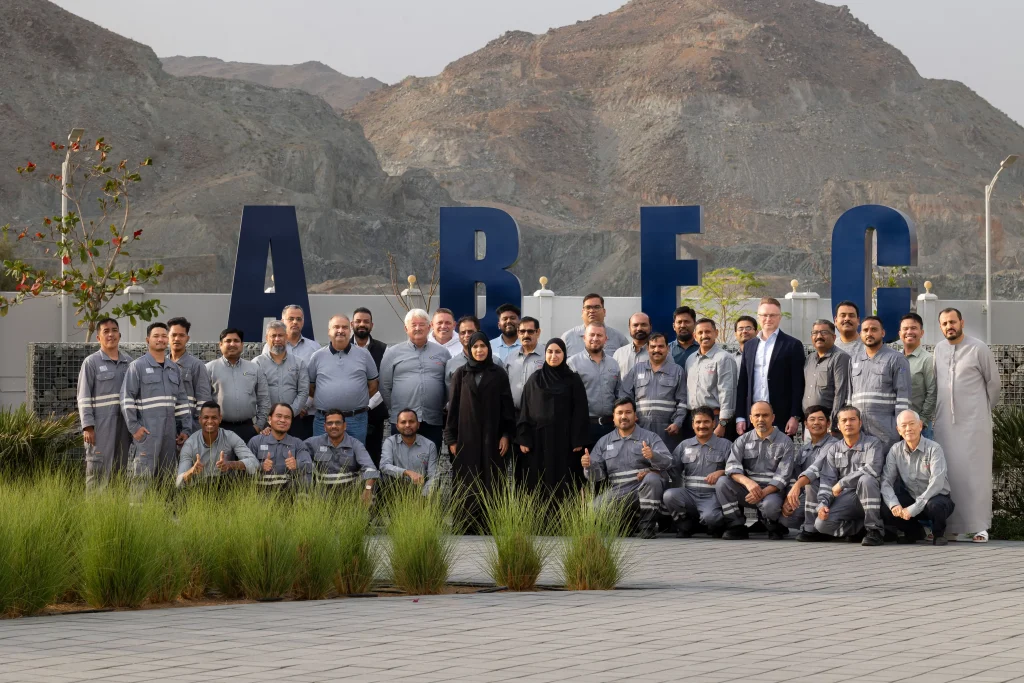 Arab Basalt Fiber Company team posing outside the company building with the logo